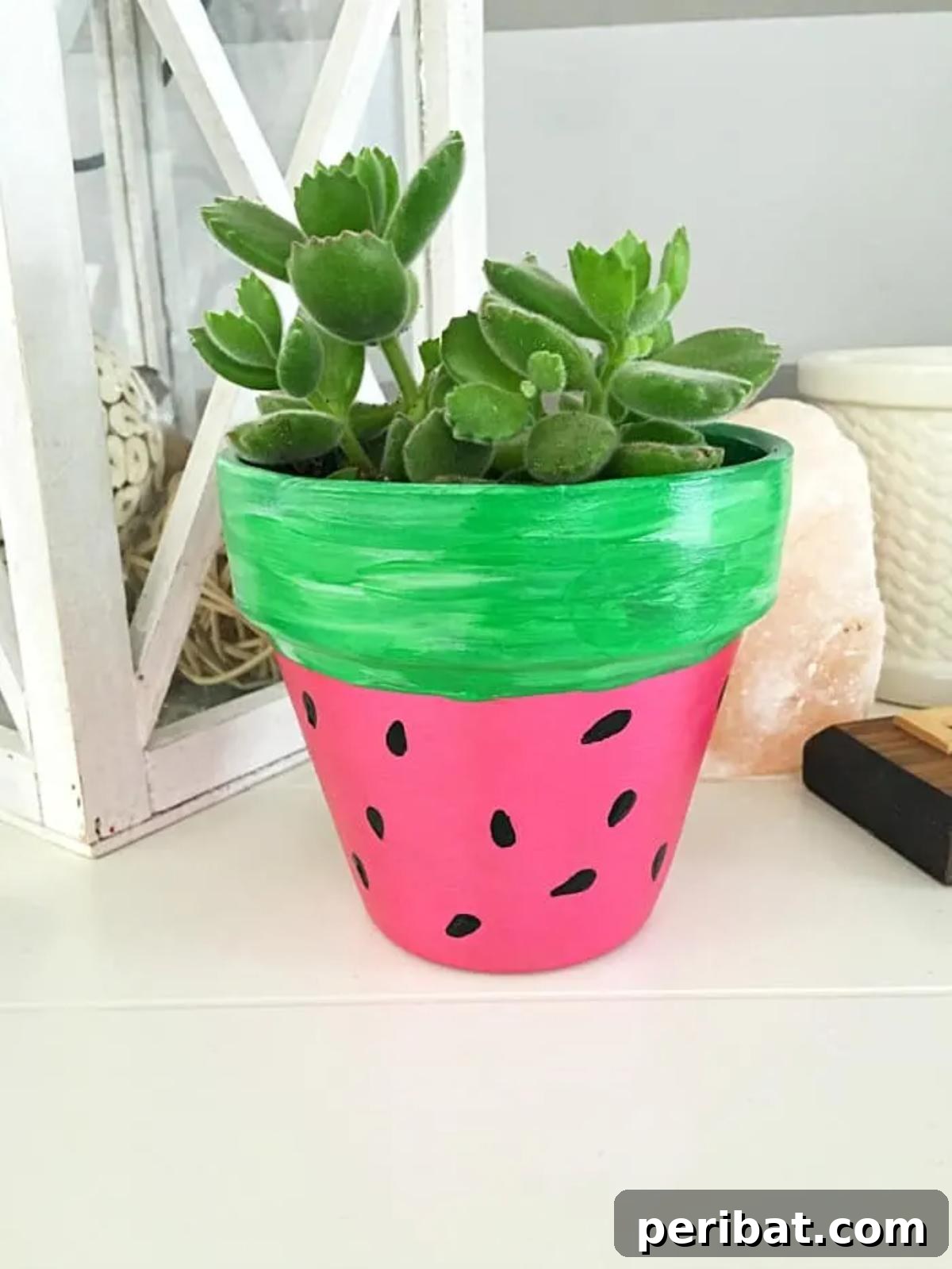 39 Juicy Watermelon Craft Ideas 16 Vibrantly hand-painted watermelon flower pot, perfect for adding a summery touch to gardening and home decor.