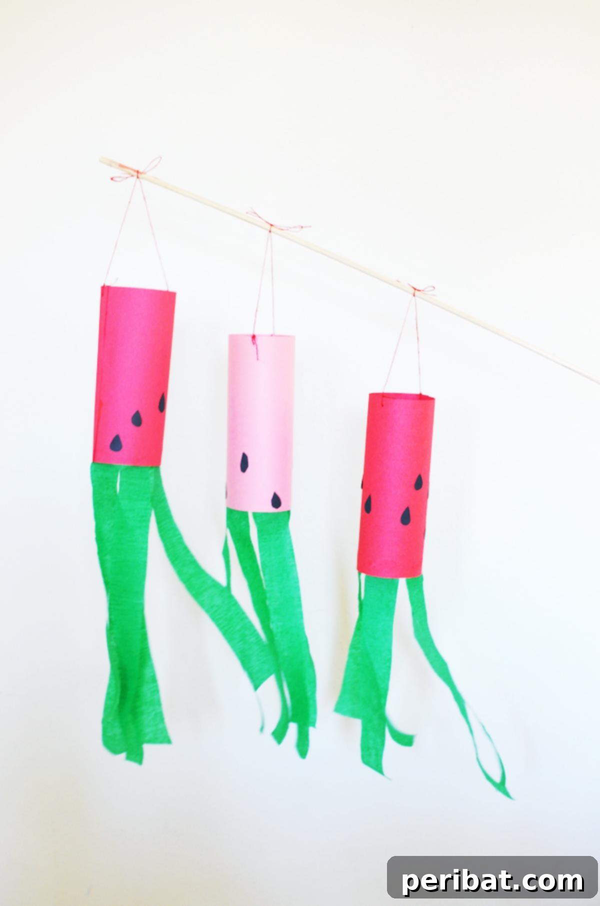 39 Juicy Watermelon Craft Ideas 7 Handmade paper watermelon windsocks swaying gently, adding a cheerful touch to outdoor spaces.