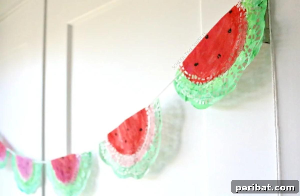 39 Juicy Watermelon Craft Ideas 8 Handmade watermelon garland craft, featuring colorful slices, ideal for vibrant summer home decor.