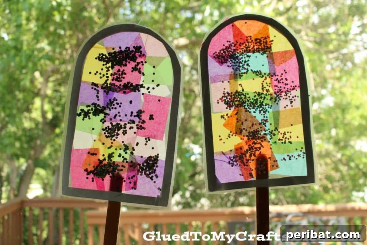 23 Vibrant DIY Tissue Paper Suncatcher Projects 17 A collection of colorful popsicle-shaped suncatchers made with tissue paper, resembling frozen treats.