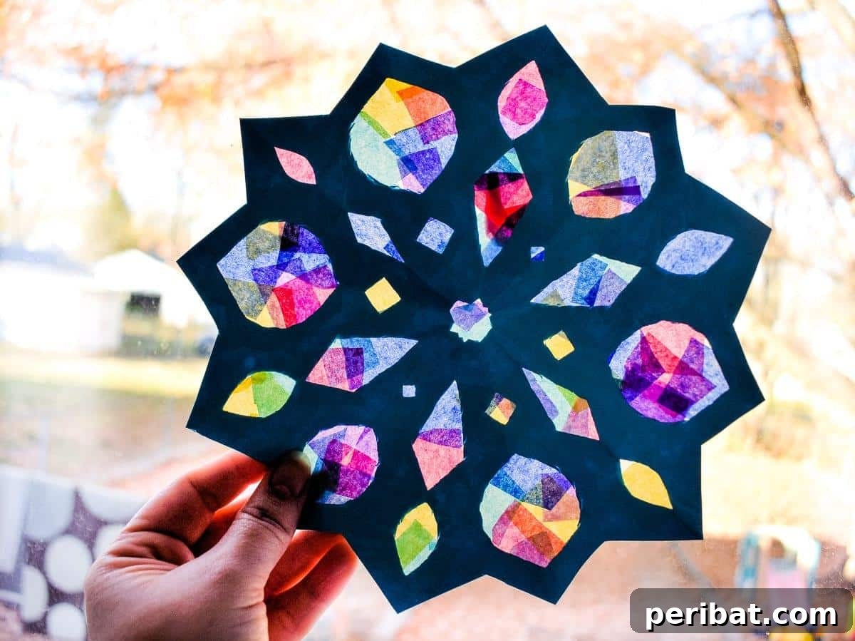 23 Vibrant DIY Tissue Paper Suncatcher Projects 18 An intricate snowflake suncatcher made with white and blue tissue paper, creating a winter wonderland effect.