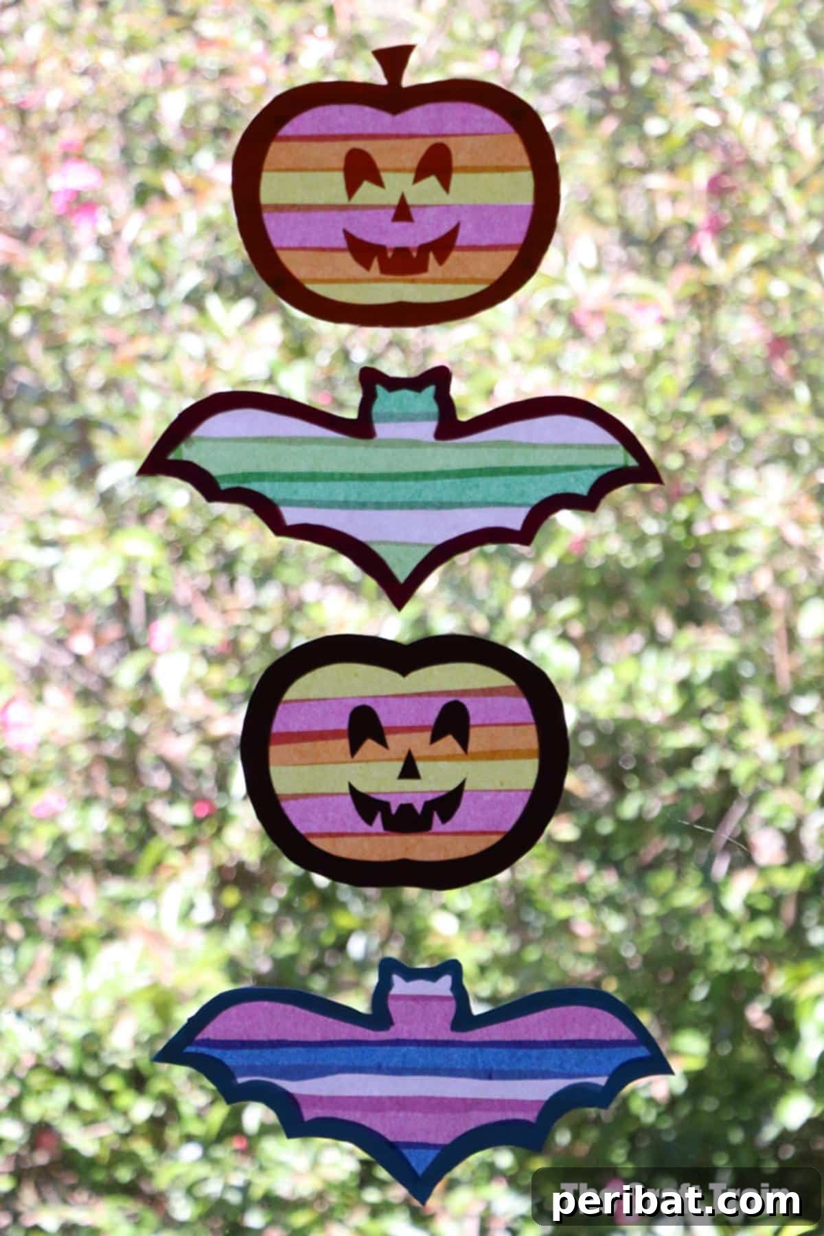 23 Vibrant DIY Tissue Paper Suncatcher Projects 4 A collection of Halloween-themed suncatchers, including ghosts, pumpkins, and bats, made with colorful tissue paper.