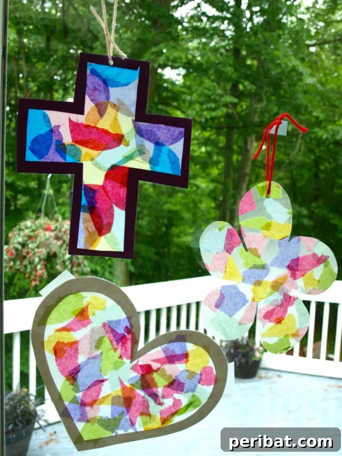 23 Vibrant DIY Tissue Paper Suncatcher Projects 6 A toddler's hand pointing at a simple tissue paper suncatcher shaped like a circle, made with large pieces of tissue paper.
