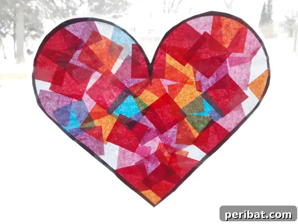 23 Vibrant DIY Tissue Paper Suncatcher Projects 9 A heart-shaped tissue paper suncatcher, showcasing various shades of red and pink.