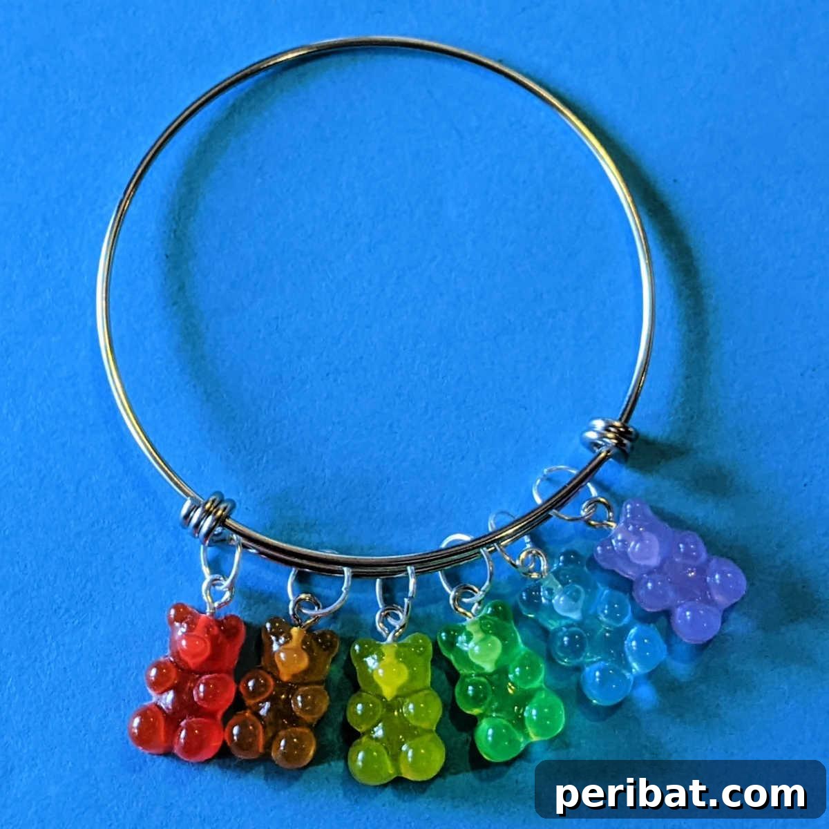 40 Brilliant Rainbow Craft Projects 22 A child's hand wearing an easy rainbow bear bangle bracelet craft