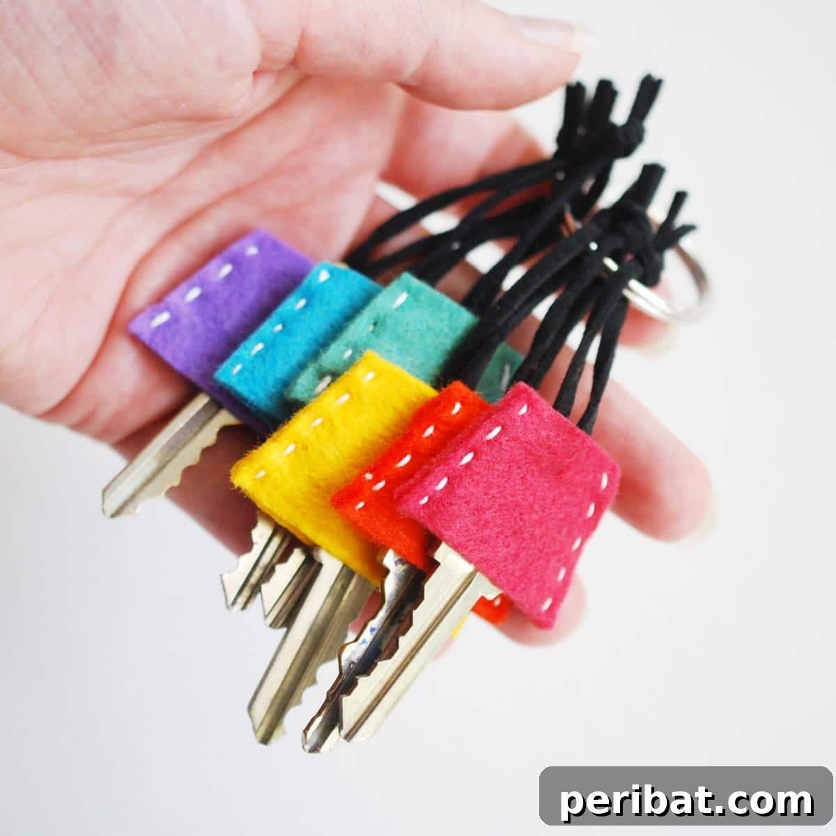 40 Brilliant Rainbow Craft Projects 23 A collection of tumbler-shaped rainbow felt key covers on a keychain