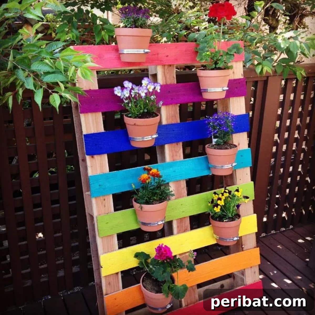 40 Brilliant Rainbow Craft Projects 26 A DIY upcycled rainbow pallet flower garden planter filled with vibrant flowers