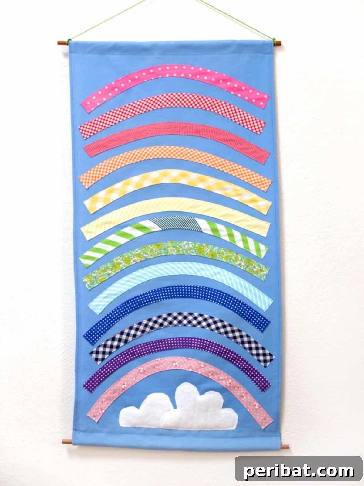 40 Brilliant Rainbow Craft Projects 28 A vibrant rainbow wall hanging art piece made with yarn and a wooden dowel