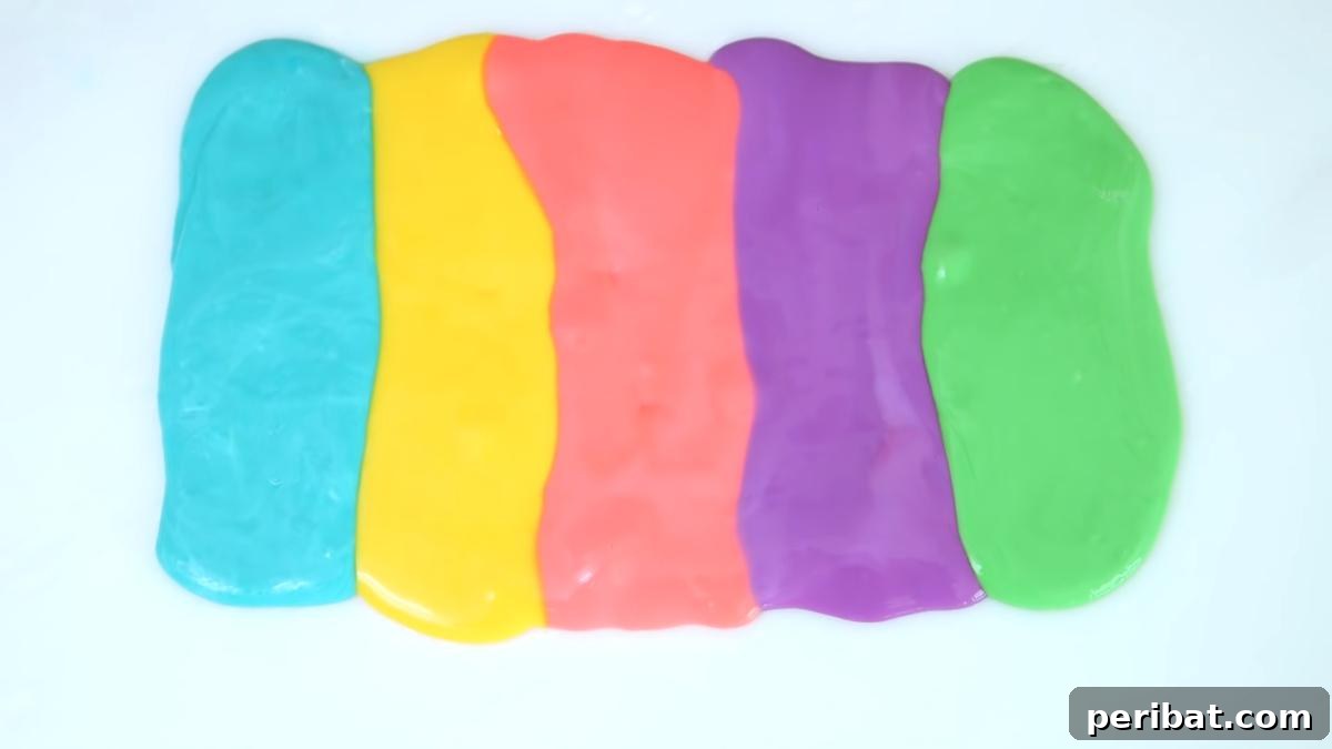 40 Brilliant Rainbow Craft Projects 4 Kids playing with colorful DIY rainbow slime, stretching and mixing it