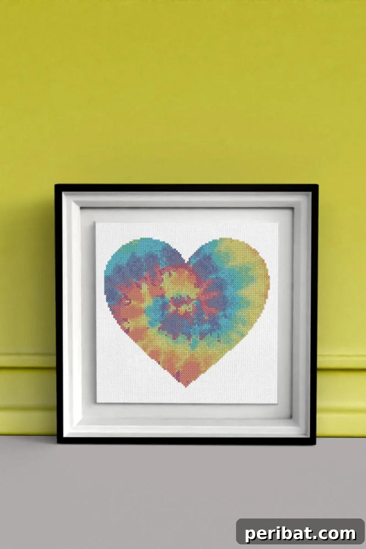 40 Brilliant Rainbow Craft Projects 31 A vibrant cross stitch tie-dye rainbow heart art piece, perfect for framing