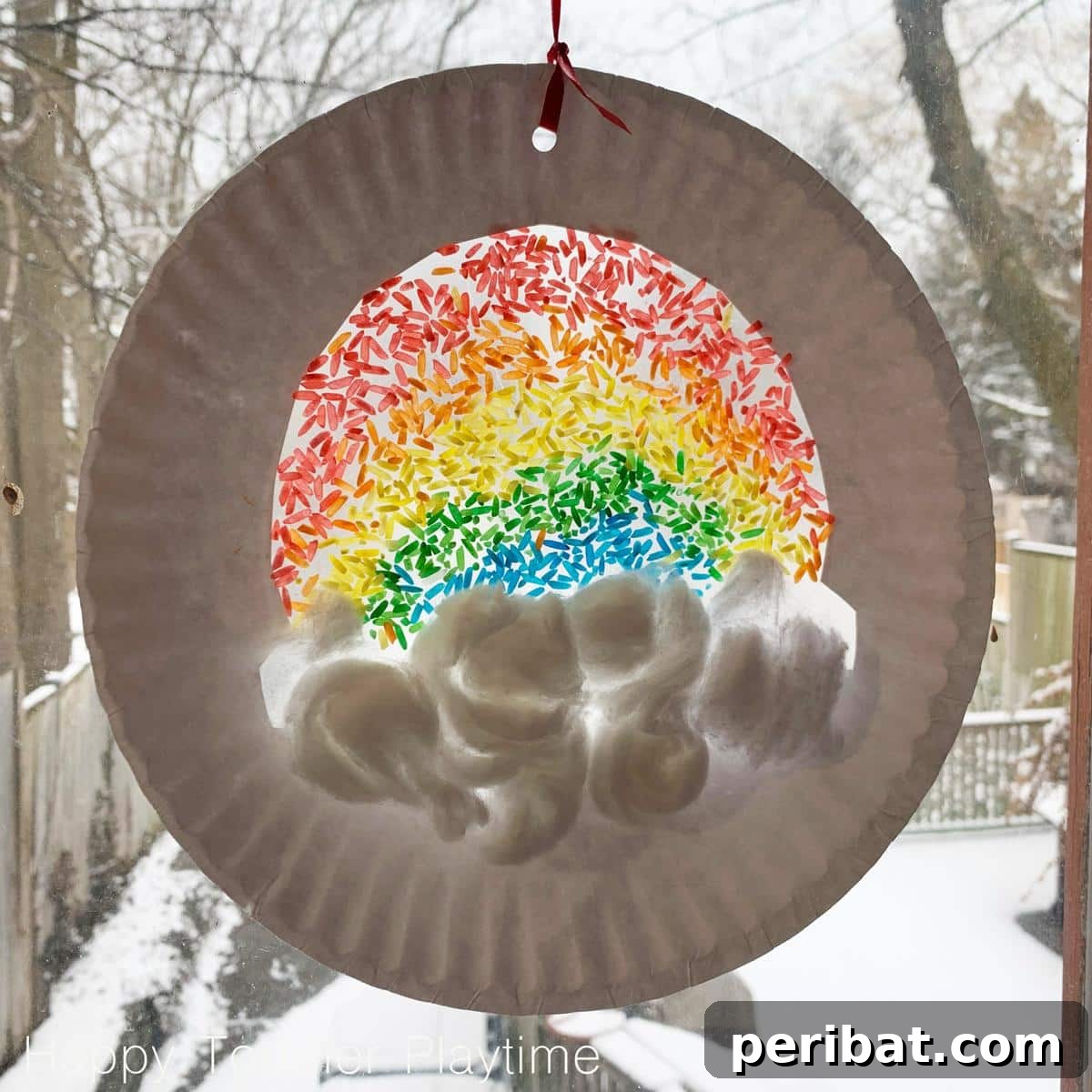 40 Brilliant Rainbow Craft Projects 37 A colorful rainbow sun catcher craft hanging in a window, casting vibrant light