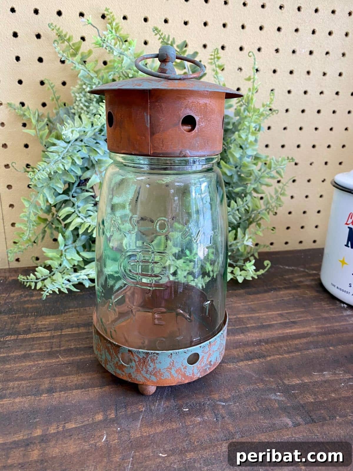 Mason Jar Magic: 20 DIY Tissue Paper Lanterns 22 A rustic mason jar lantern with a metal lid and base, exuding vintage charm.