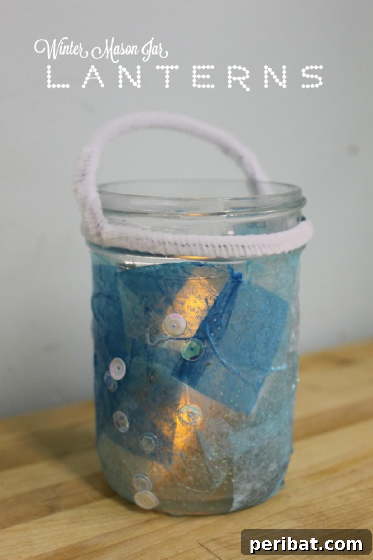 Mason Jar Magic: 20 DIY Tissue Paper Lanterns 9 Serene winter-themed mason jar lanterns, adorned with cool-toned tissue paper for a moonlit ambiance.