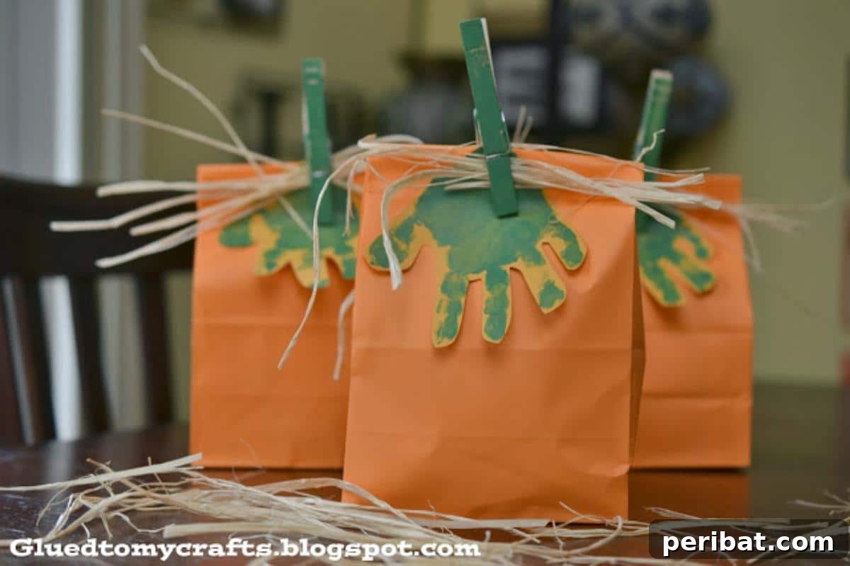 Paper Bag Masterpieces Made Effortless 27 Festive handprint pumpkin gift bags, adorned with unique handprints, perfect for Halloween or fall treats.