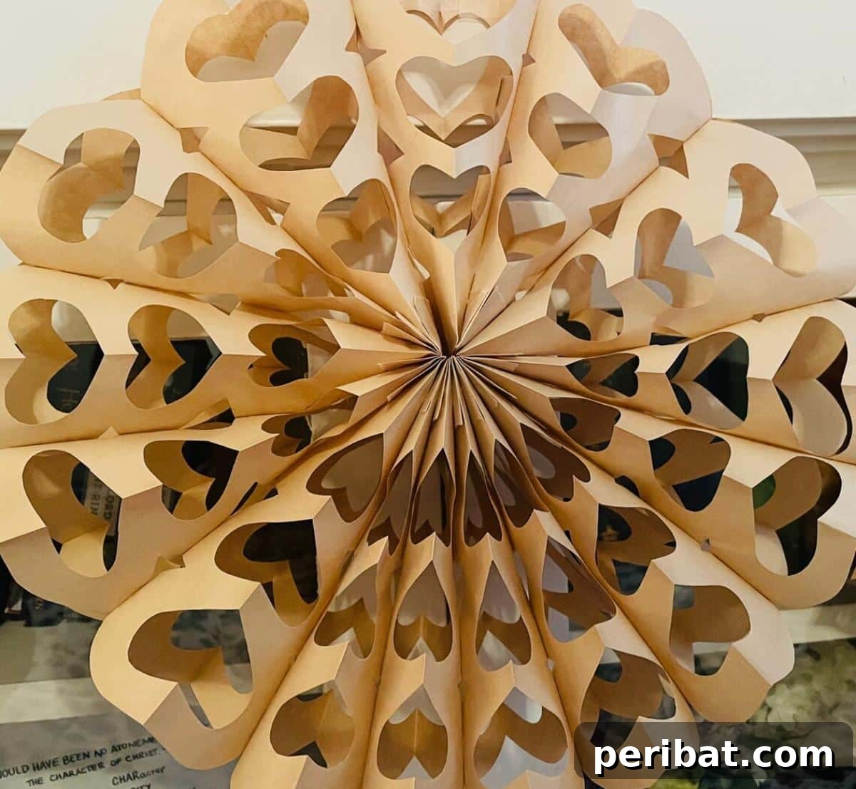 Paper Bag Masterpieces Made Effortless 42 Intricate paper bag snowflakes, showcasing delicate designs of hearts and Christmas trees, ideal for festive decoration.