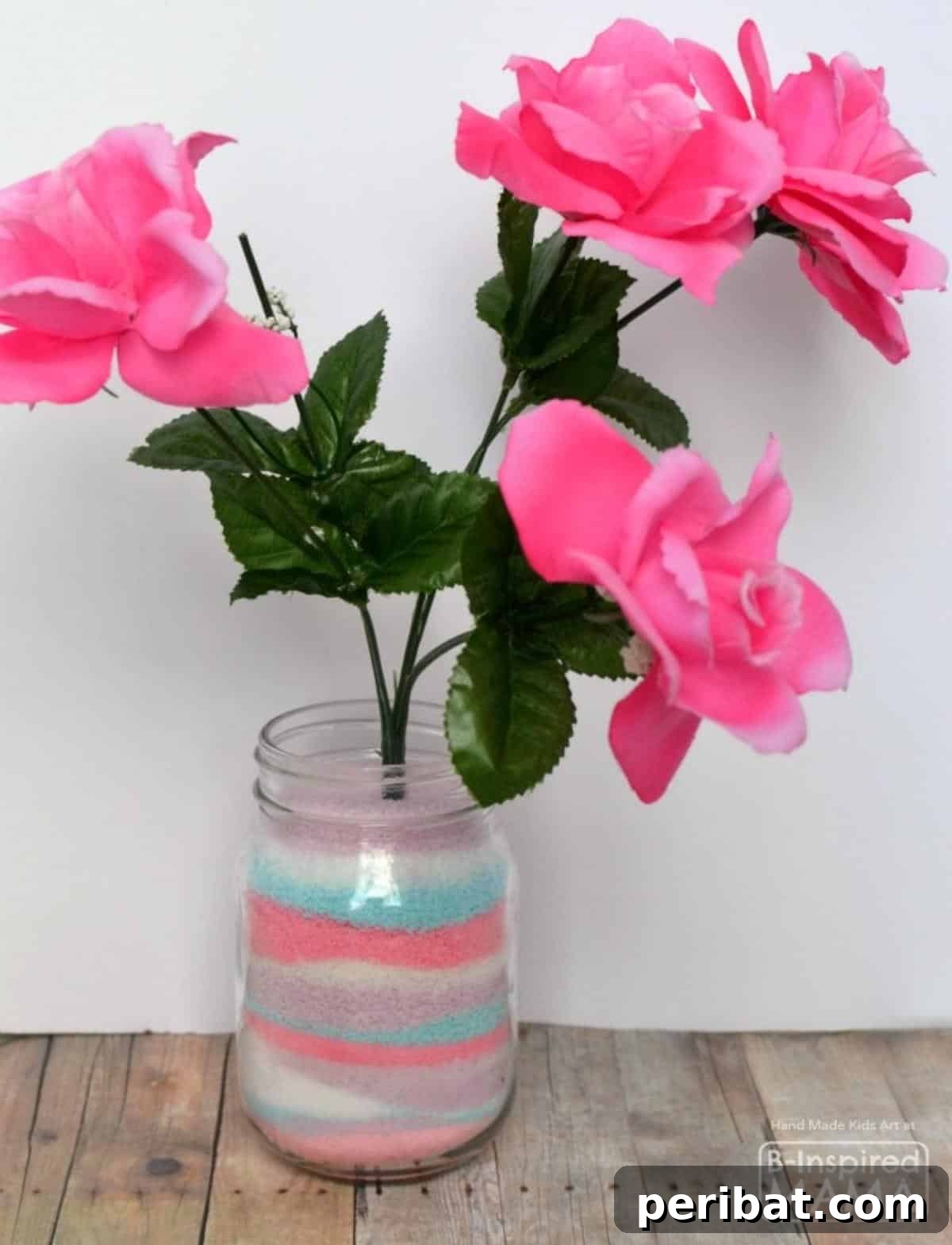 Crafting Colorful Salt Jars 25 Project Ideas 19 A heartfelt Kids Salt Art Centerpiece, ideal as a Mother’s Day craft, showcasing a colorful salt art vase topped with cheerful artificial flowers. A truly personalized and bright gift.
