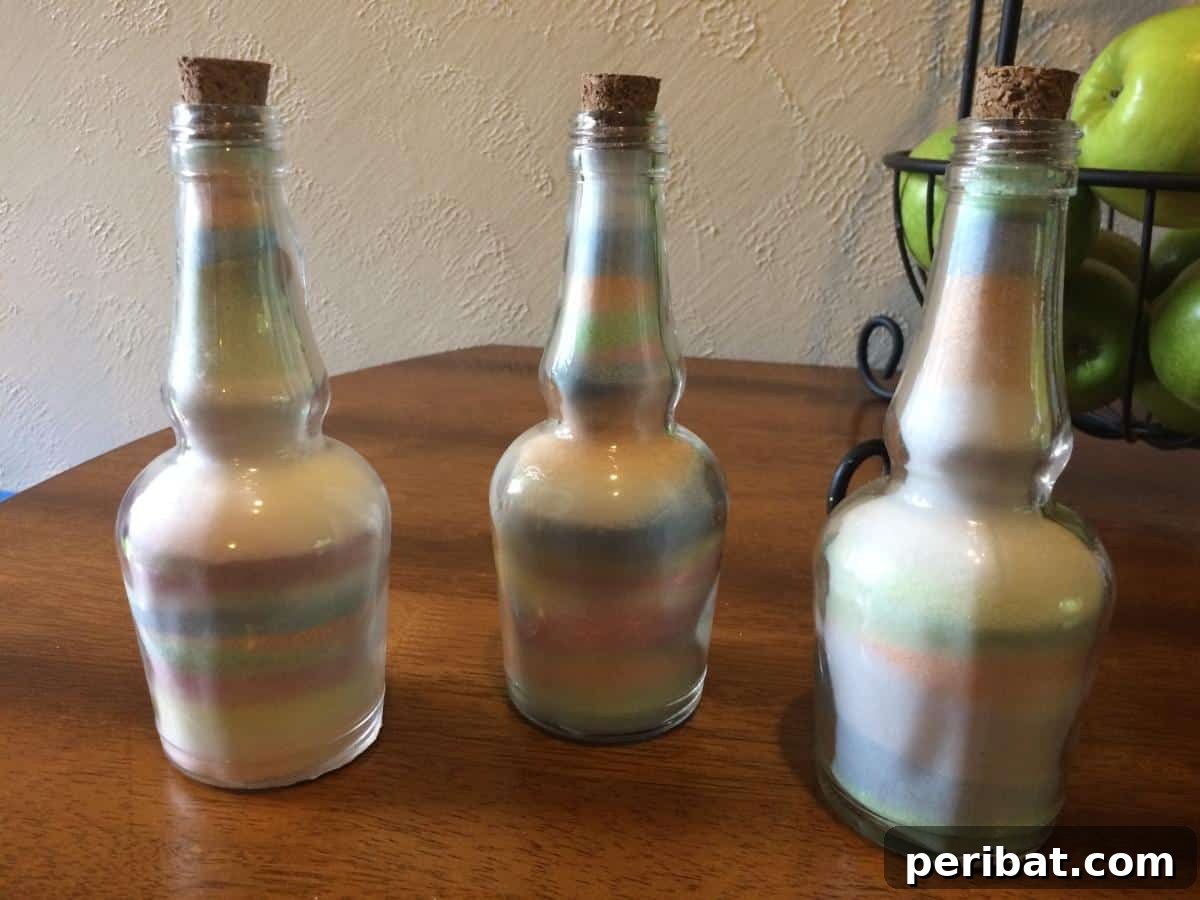 Crafting Colorful Salt Jars 25 Project Ideas 3 Beautifully crafted colored salt glass bottles displayed as decorative pieces. The bottles feature various layered hues, creating a visually striking effect. Ideal for home decor or as simple, elegant gifts.