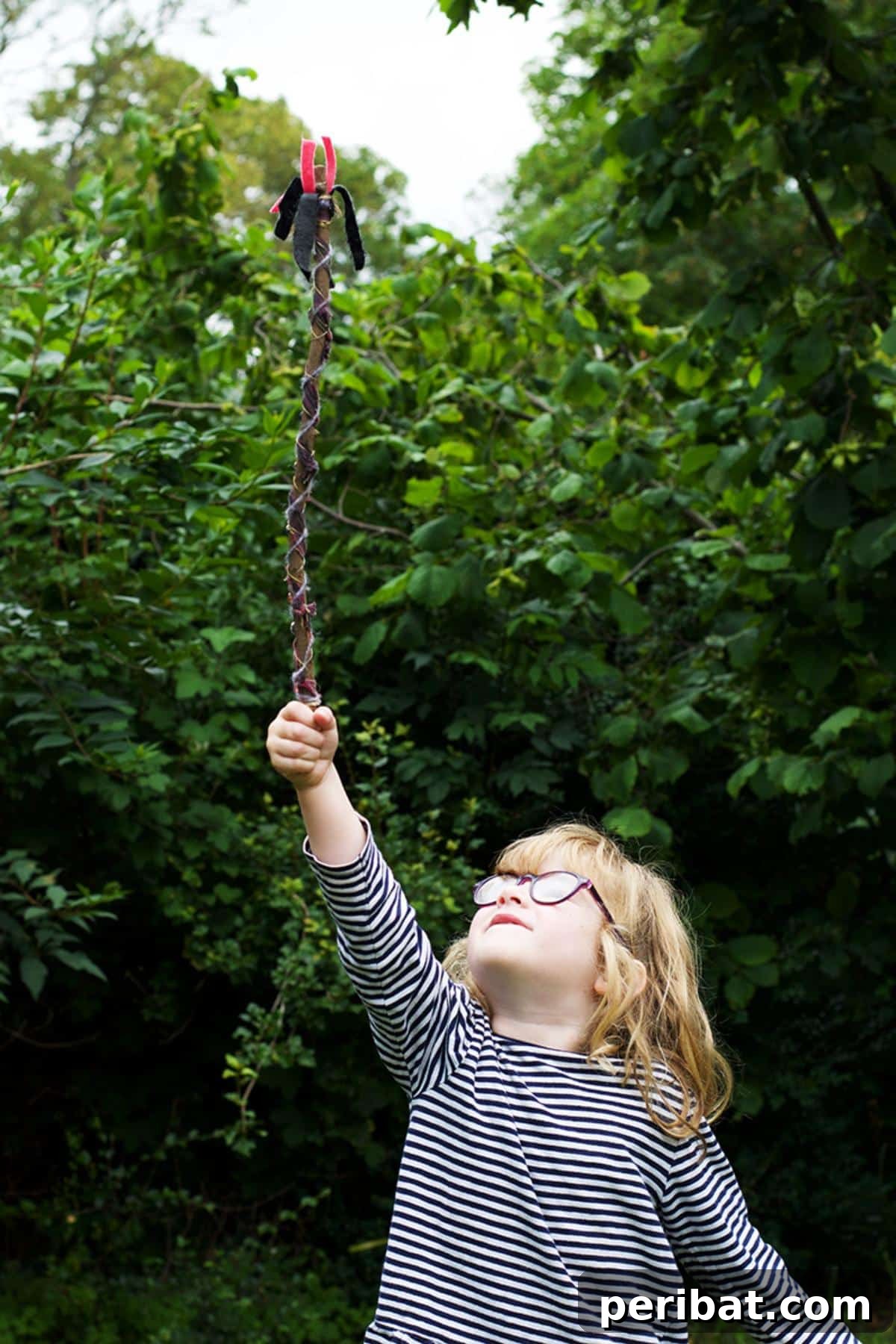 A rustic DIY Magic Wand crafted from a simple stick, adorned with natural elements.