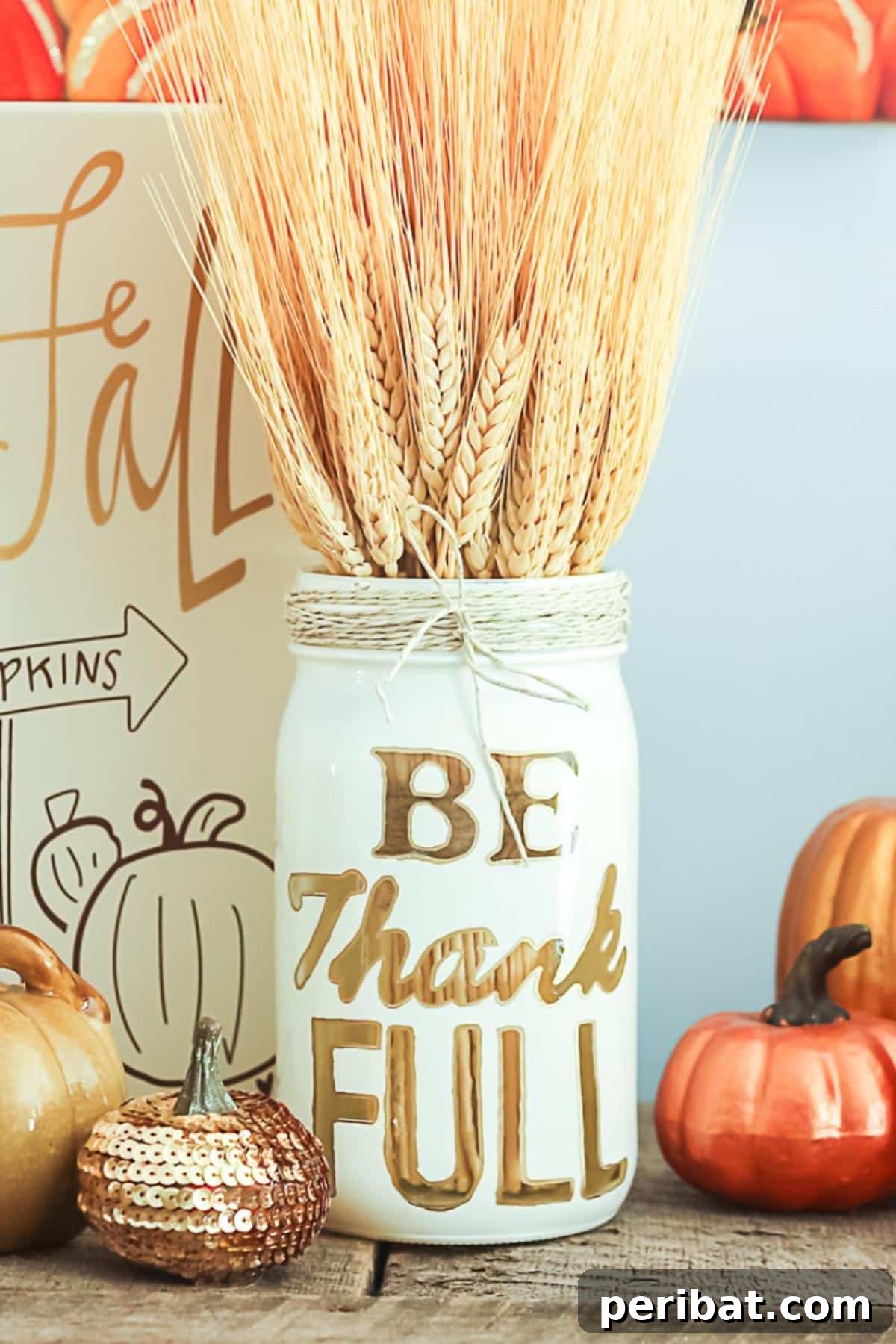 Festive DIY Thanksgiving mason jars, adorned with autumnal motifs and colors.