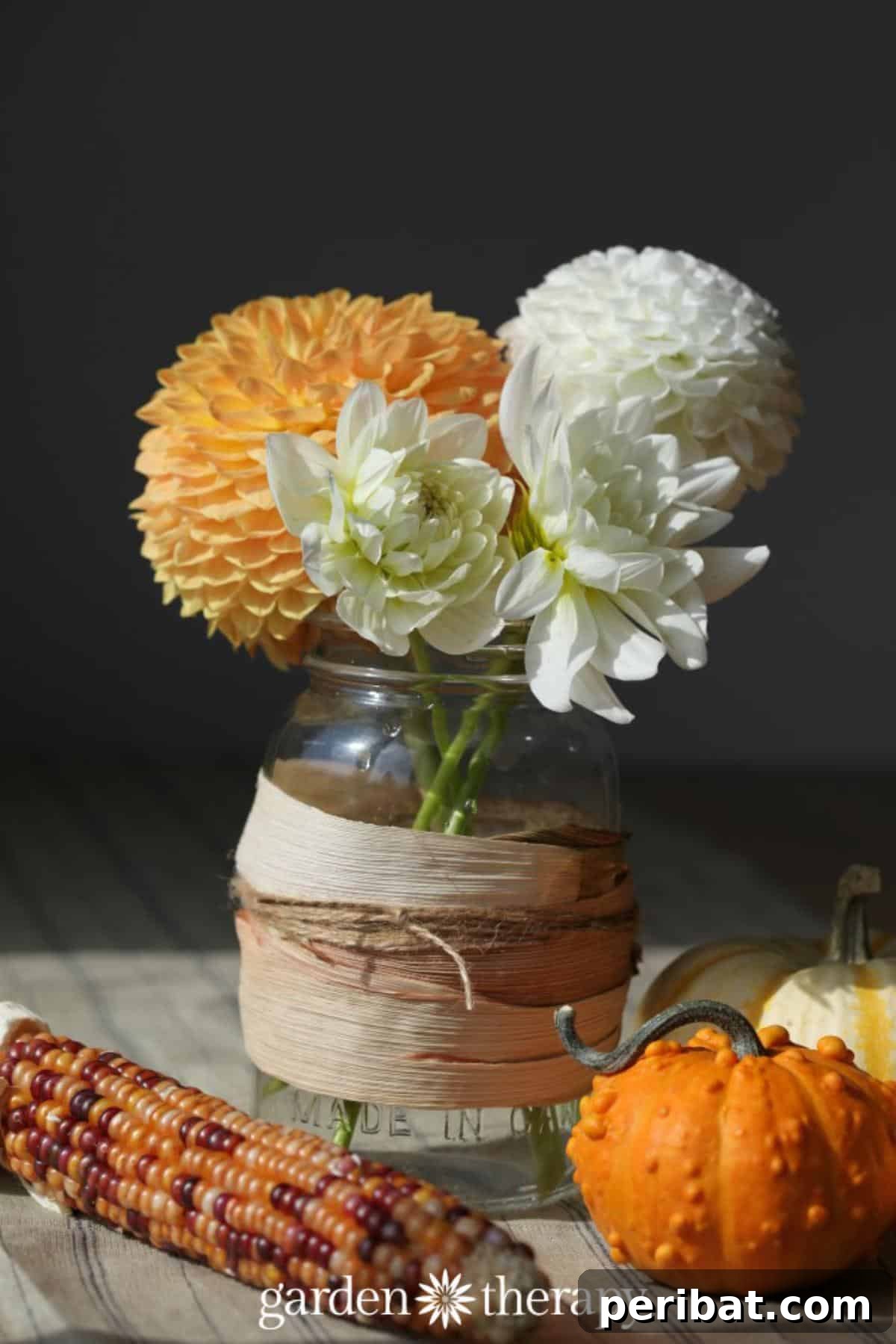 Rustic corn husk wrapped mason jar vase, perfect for fall floral arrangements.