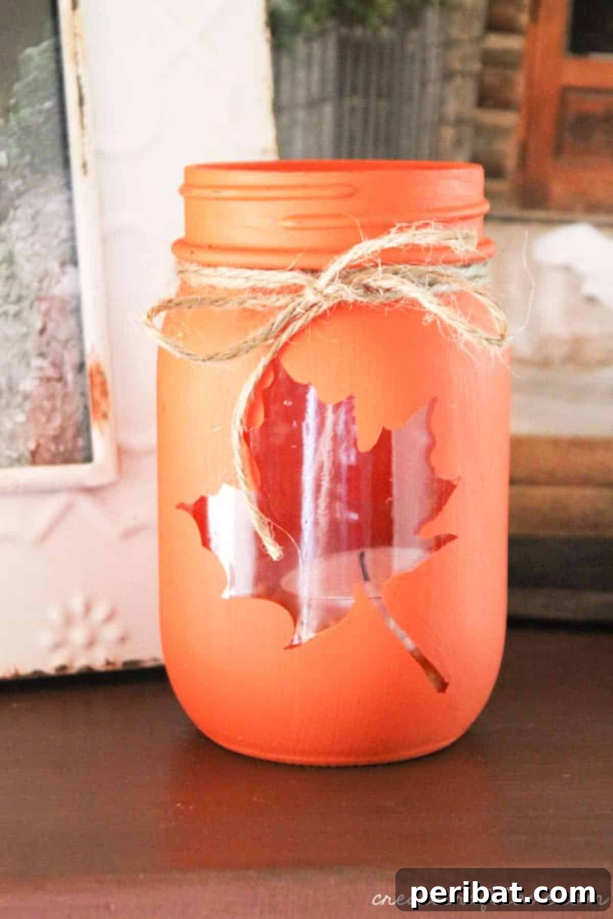 Cozy mason jar fall luminary, glowing with natural autumn elements.