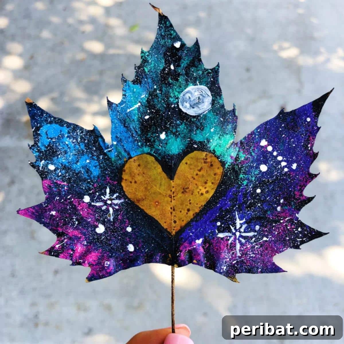 A stunning galaxy-painted leaf, illustrating a unique cosmic art technique.