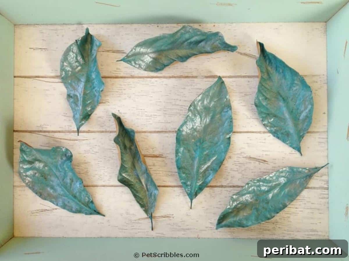 Elegant painted magnolia leaves, perfect for sophisticated fall decor and wedding embellishments.