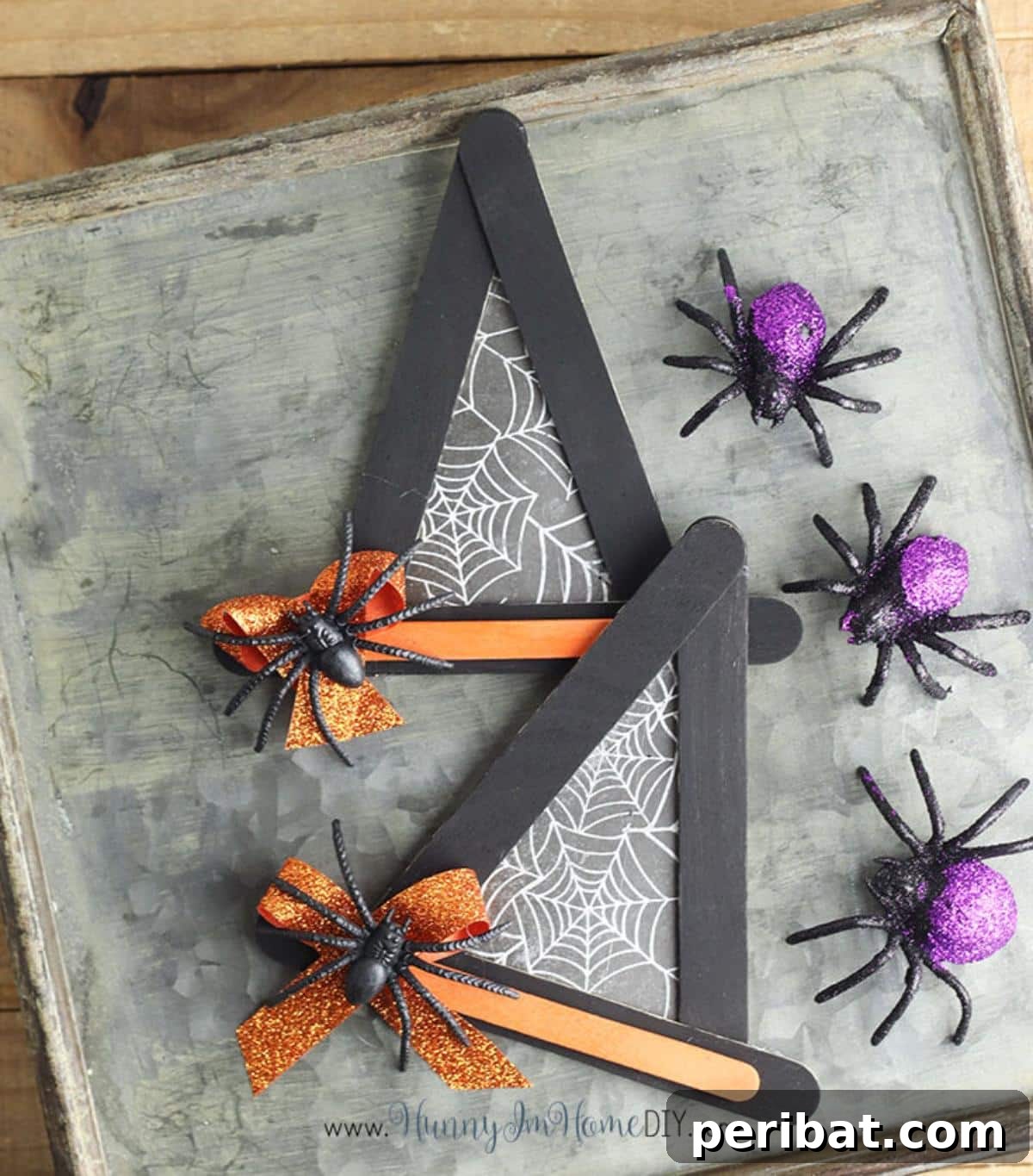 Spooktacular Popsicle Stick Halloween Projects 15 A miniature witch hat Halloween craft made from black-painted popsicle sticks, decorated with a faux spider and web.