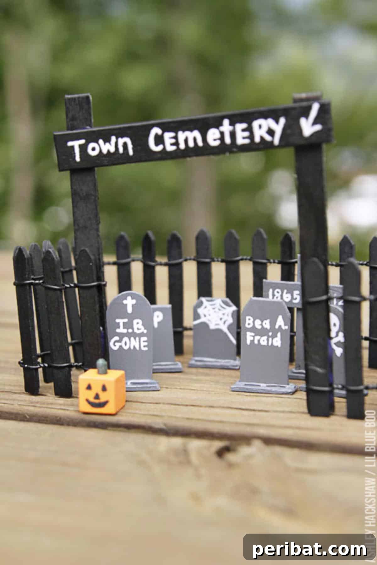 Spooktacular Popsicle Stick Halloween Projects 25 A miniature cemetery scene created with popsicle stick tombstones, featuring spooky names and details.