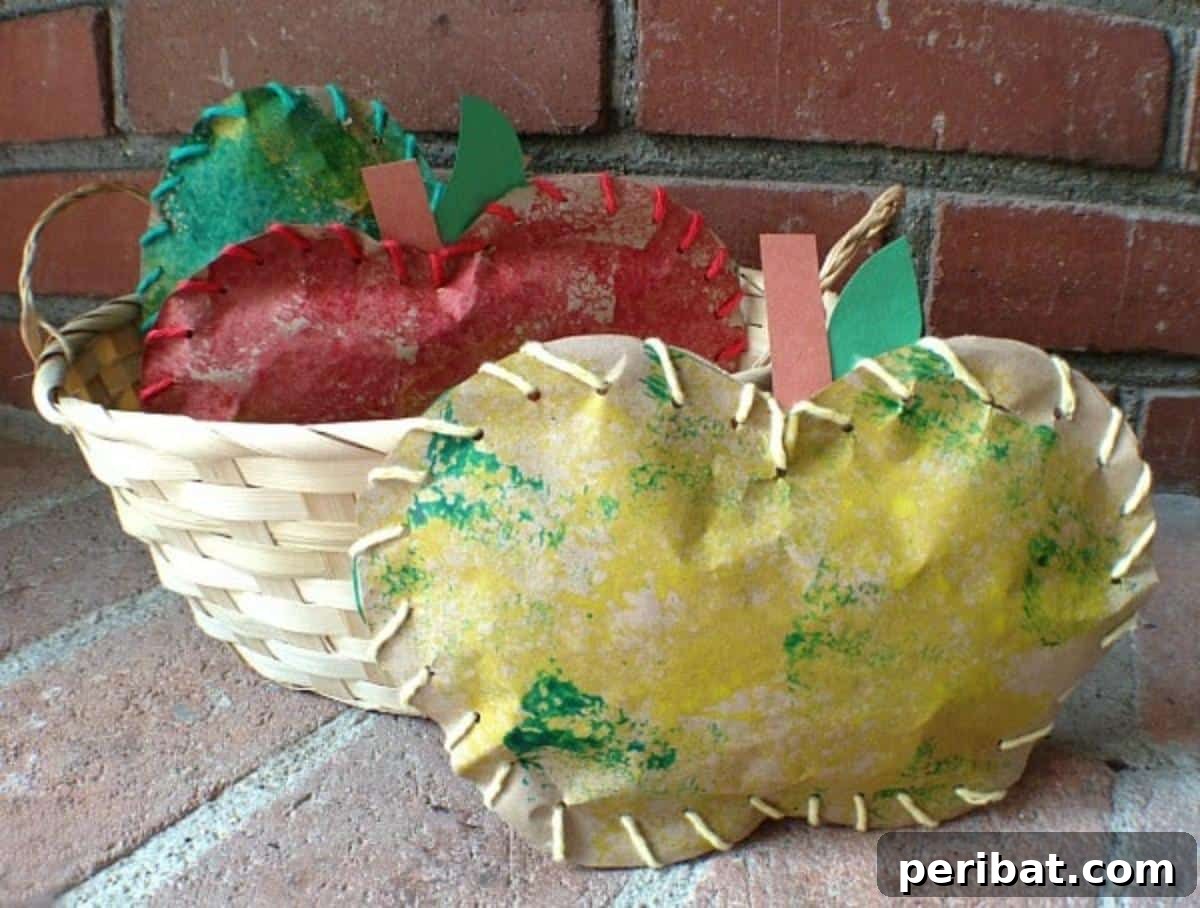 26 Autumnal Paper Bag Crafting Gems 20 Charming stuffed paper apples, crafted with sponge painting and lacing, ideal for kids' fall crafts.