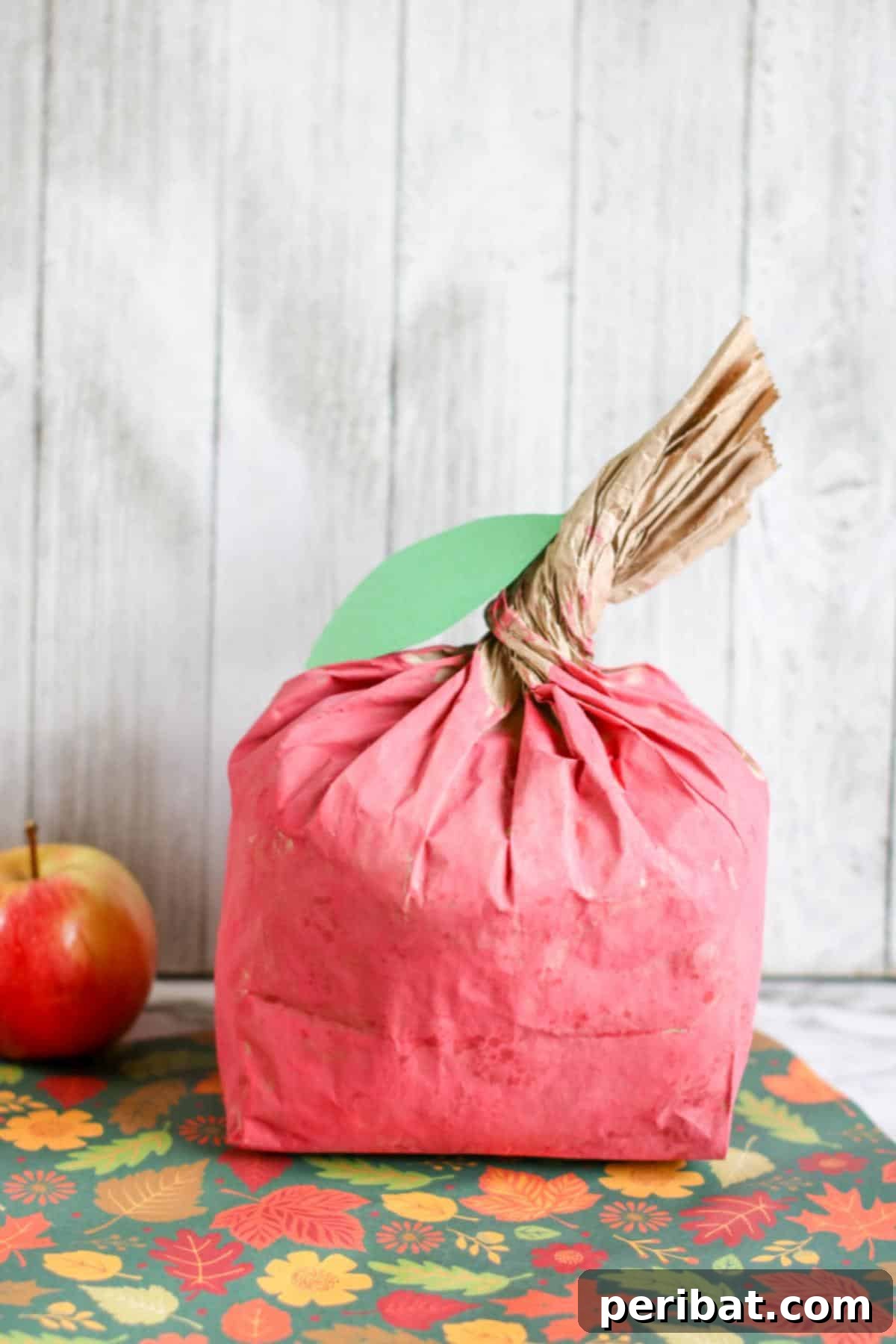 26 Autumnal Paper Bag Crafting Gems 6 Vibrant red apple-shaped paper bag crafts, perfect for autumn-themed classroom activities.