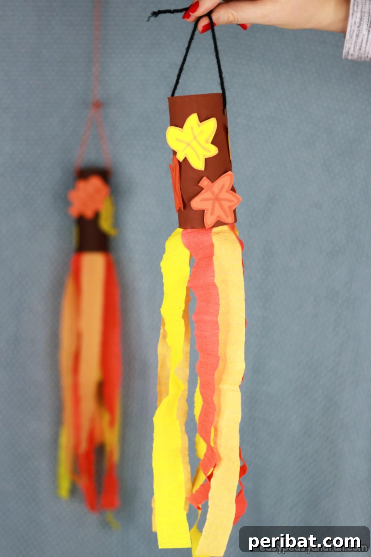 Fall Windsock Toilet Paper Roll Craft with colorful streamers