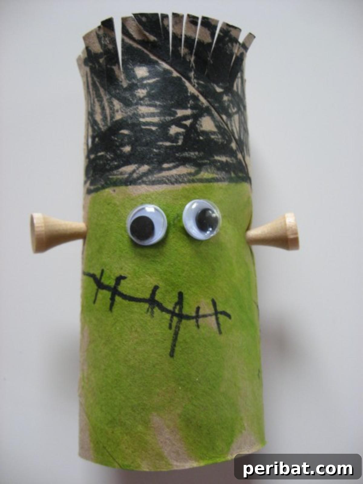 Frankenstein Craft made from a toilet paper roll with green paint and bolts.