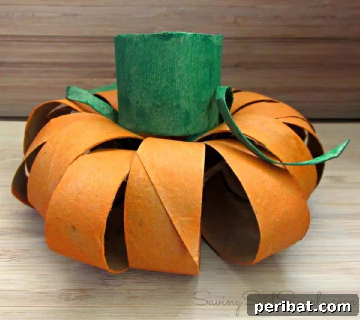 Toilet Paper Roll Pumpkin for Kids, painted orange with a green stem.