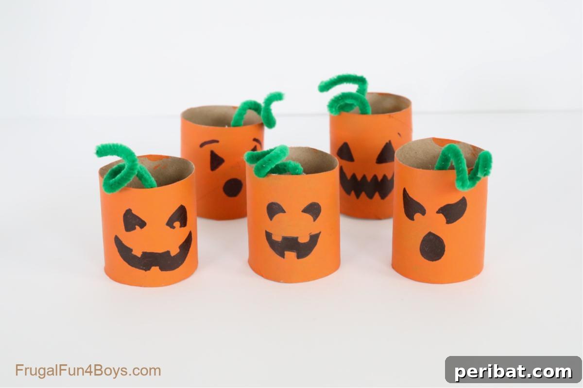 Paper Roll Pumpkin Craft, painted orange with a friendly jack-o'-lantern face.