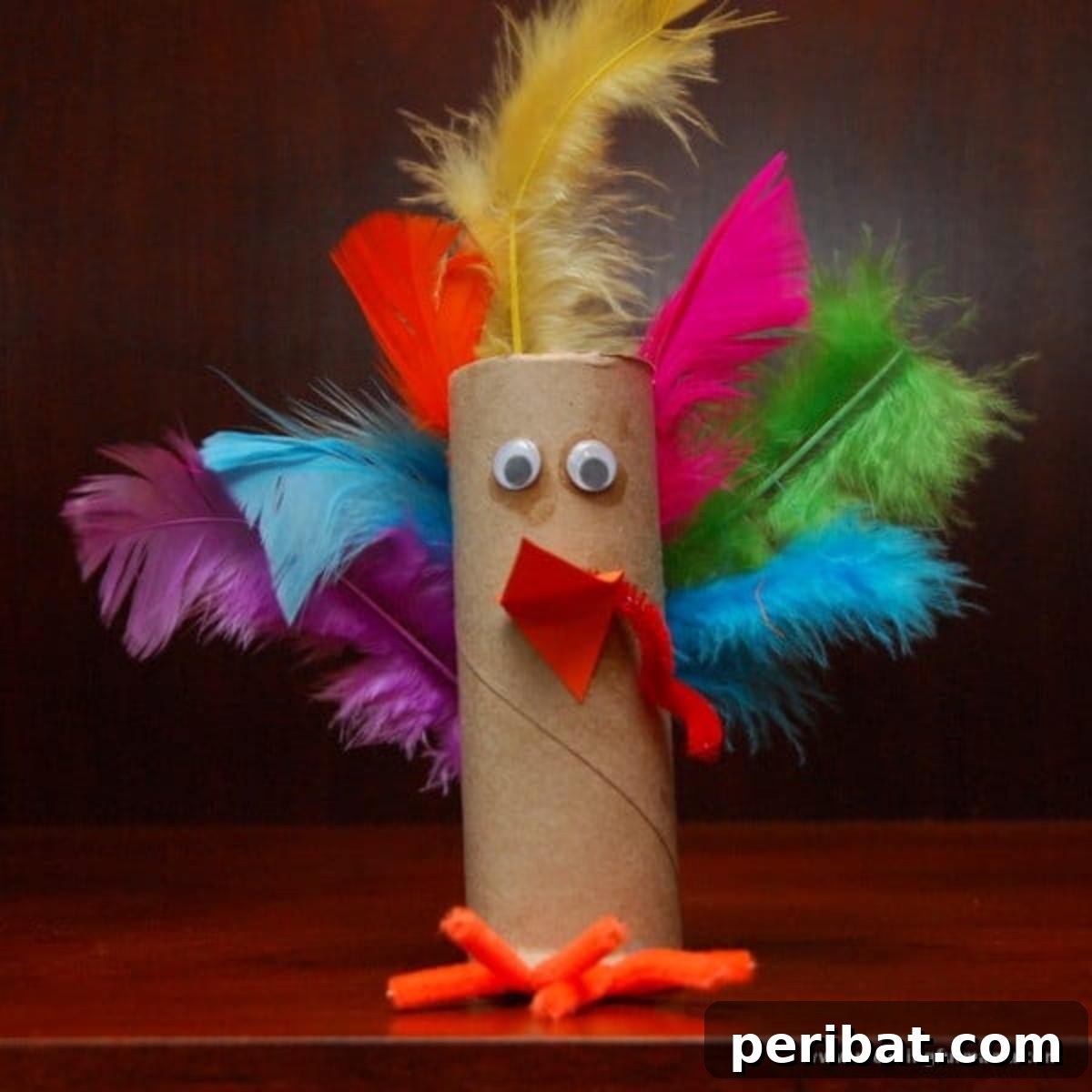 Toilet Paper Roll Turkey craft with colorful paper feathers.