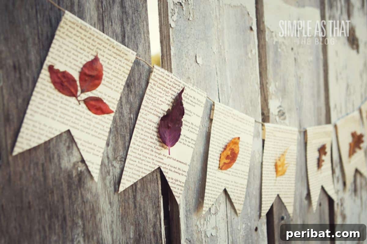 A whimsical DIY fall leaf banner crafted from repurposed book pages and autumn leaves, creating a unique decorative piece with a literary and seasonal charm.