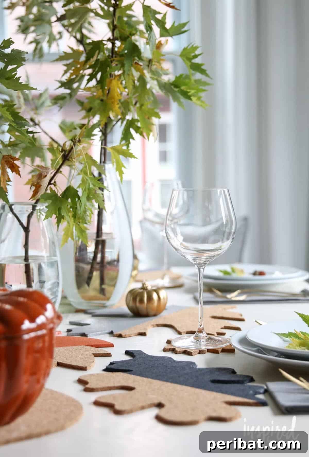 Stylish fall colorblock cork table decor, featuring various leaf shapes cut from cork and arranged in a modern design, perfect for contemporary autumn gatherings.