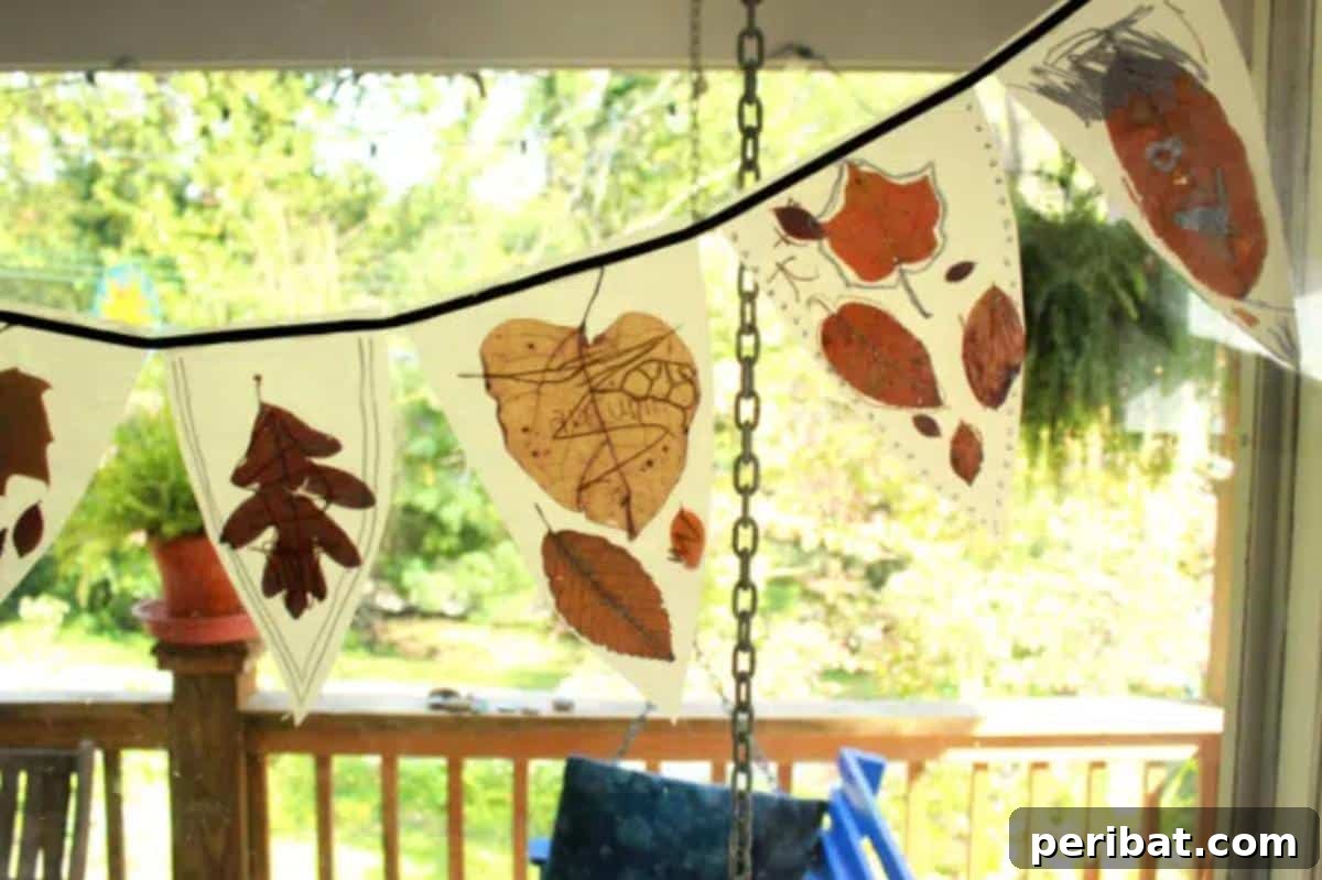 A colorful autumn leaf bunting, created by children using wax paper and natural leaves, perfect for adding a festive and earthy touch to any room.