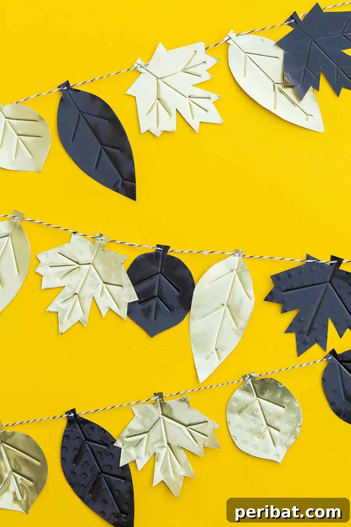 A sophisticated DIY metal fall leaf garland, featuring intricately embossed metal leaves strung together to create a unique and shimmering seasonal decoration.