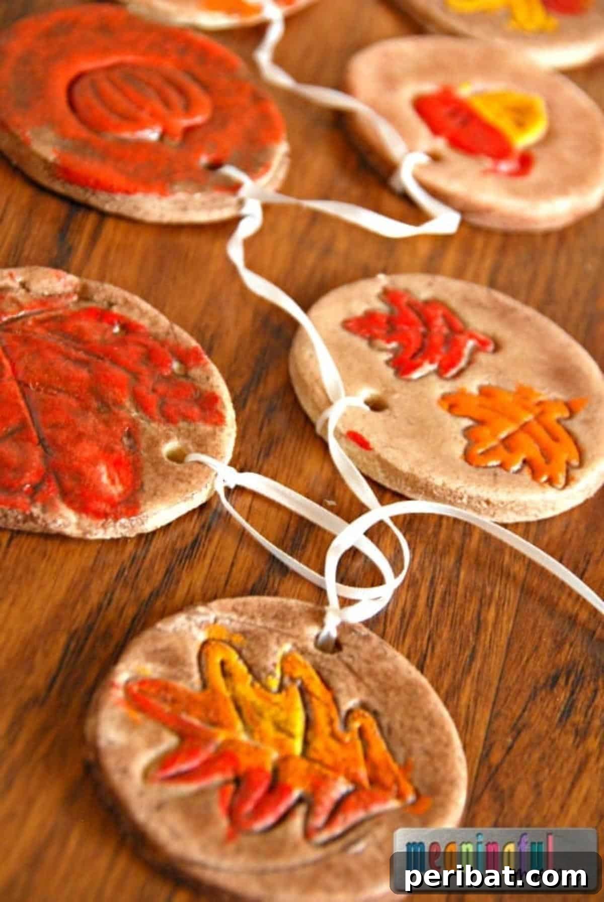 Delightful fall salt dough ornaments shaped like autumn leaves, painted in rich seasonal colors, perfect for hanging on a decorative tree or as festive gifts.