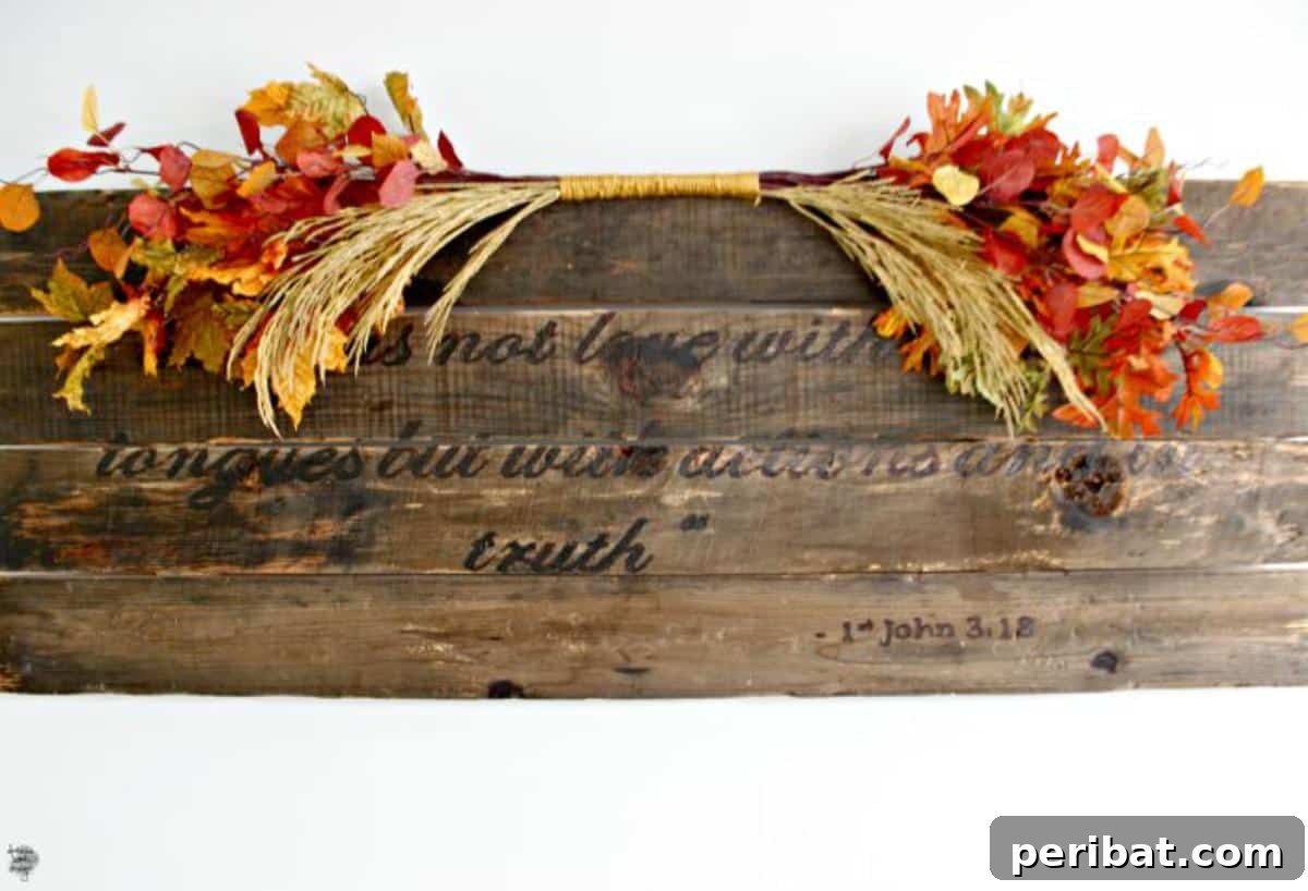 An eye-catching DIY fall leaves decoration featuring artificial leaves intertwined with thick wool yarn, creating a cozy and visually impactful autumnal display.
