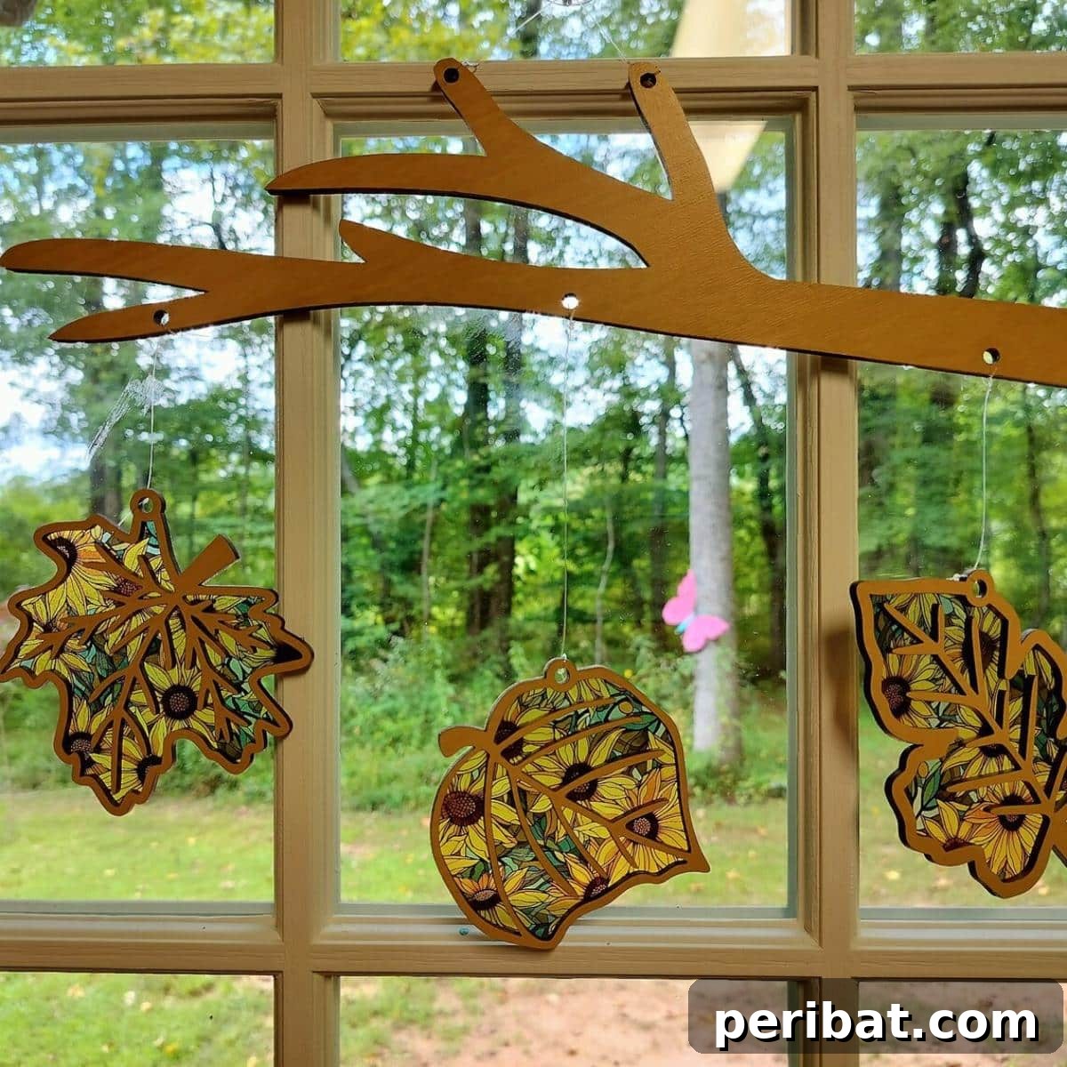 A radiant fall leaves suncatcher window hanger, capturing the natural beauty and vibrant colors of autumn foliage as light filters through, creating a stunning display in any room.