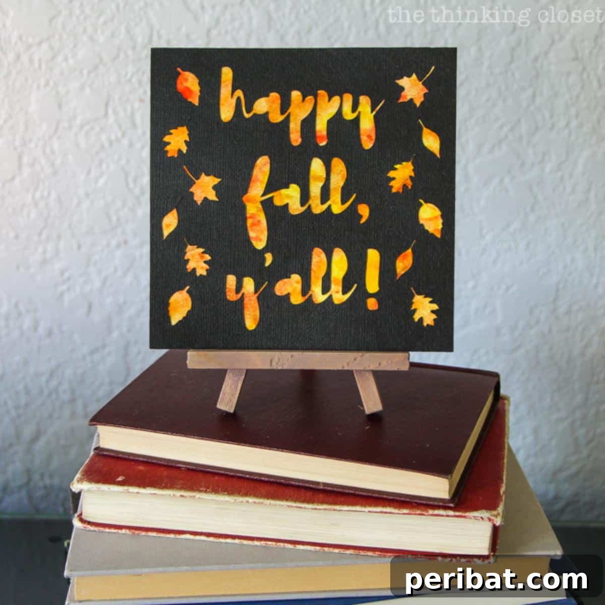 A cheerful 'Happy Fall Y'all' watercolor art piece, featuring rustic lettering and vibrant autumnal splashes, perfect for seasonal home display.