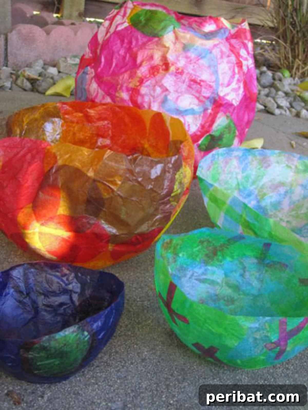 Vibrant Tissue Paper Crafts: 40 DIY Ideas 12 Tissue Paper Balloon Bowls. A playful collection of colorful, translucent bowls made from tissue paper and balloons, showcasing their unique shapes and vibrant colors.