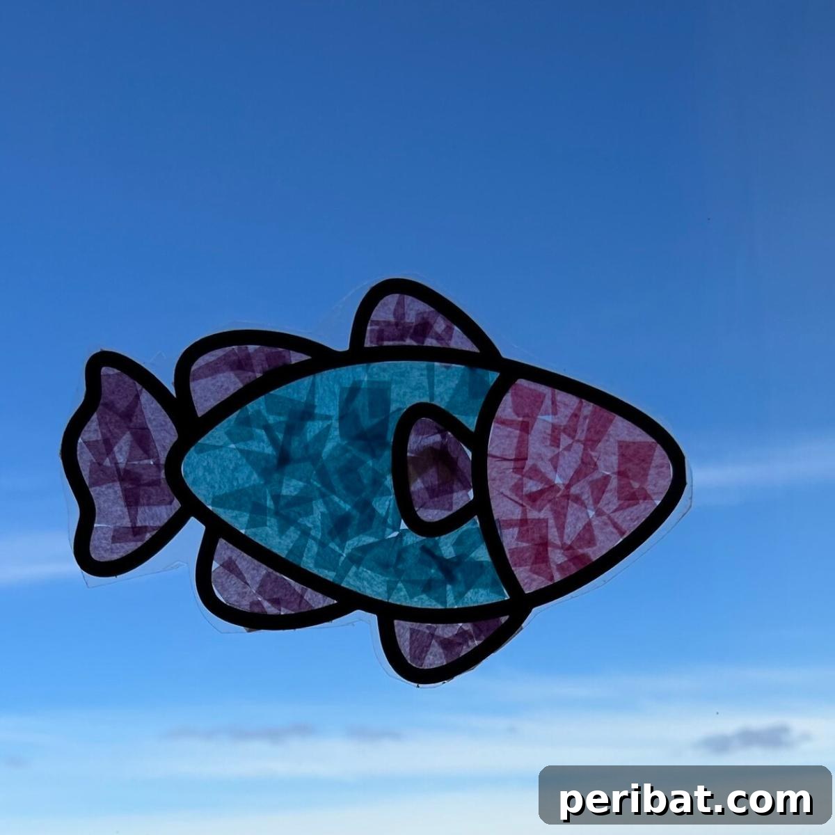 Vibrant Tissue Paper Crafts: 40 DIY Ideas 40 Large Fish Suncatcher. A large, intricately designed fish suncatcher crafted with vibrant tissue paper, glowing beautifully when light passes through, ideal as a DIY craft kit.
