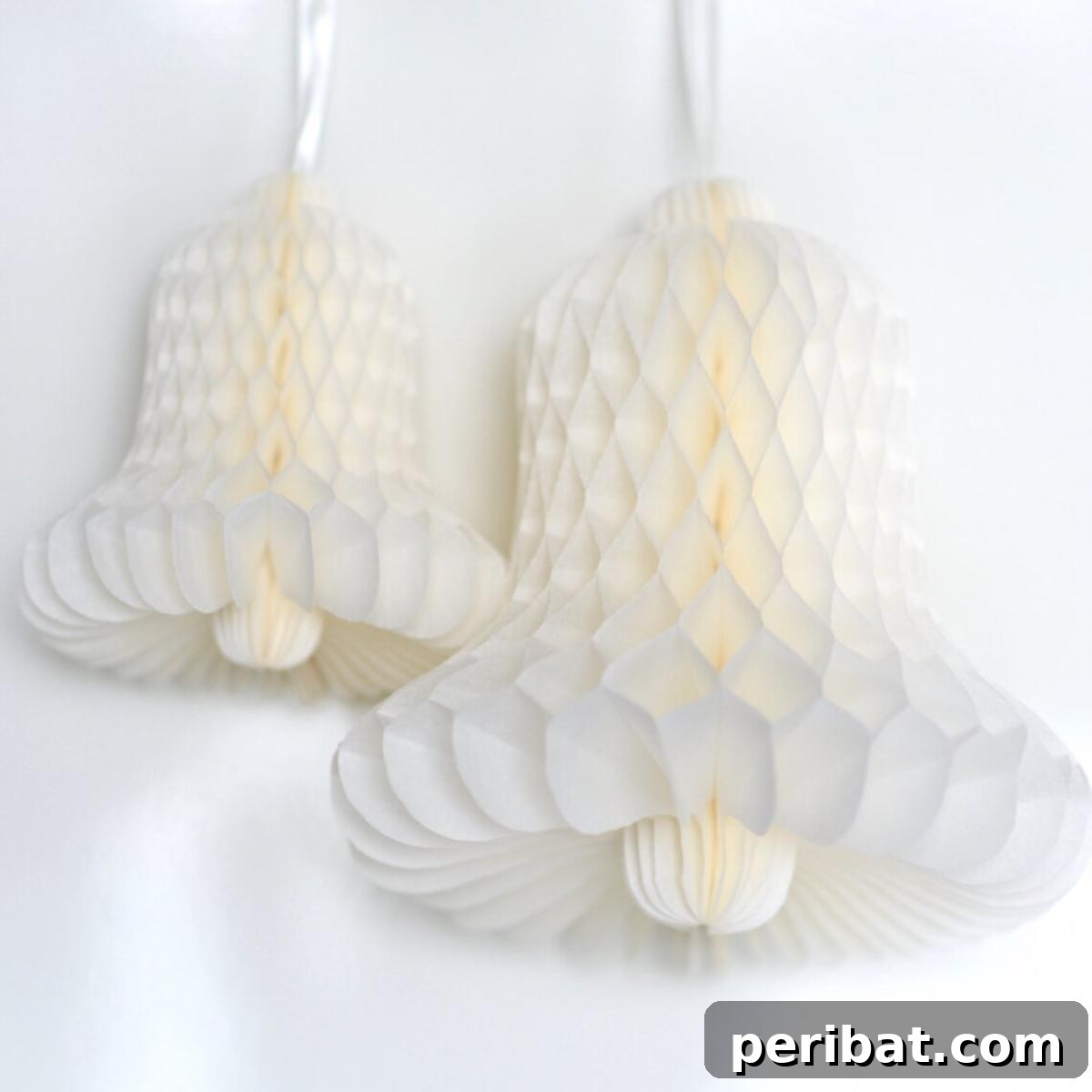 Vibrant Tissue Paper Crafts: 40 DIY Ideas 41 Tissue Paper Honeycomb Bells. Elegant tissue paper honeycomb bells in various colors, hanging gracefully, perfect for adding a festive and sophisticated touch to party decor.