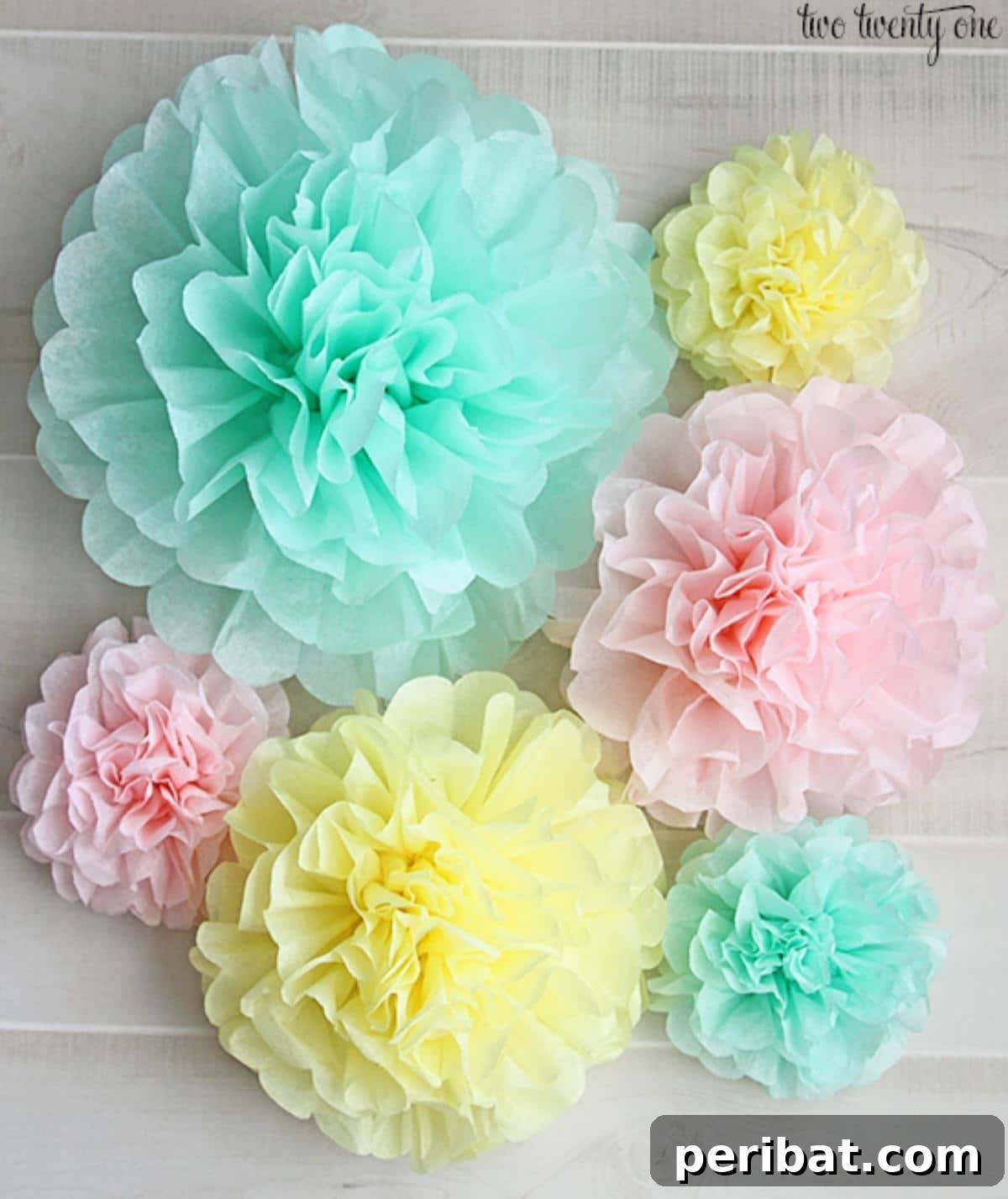 Vibrant Tissue Paper Crafts: 40 DIY Ideas 7 Tissue Paper Pom Poms. A delightful assortment of fluffy tissue paper pom-poms in pastel colors, hanging gracefully and ready to add a festive touch to any space.