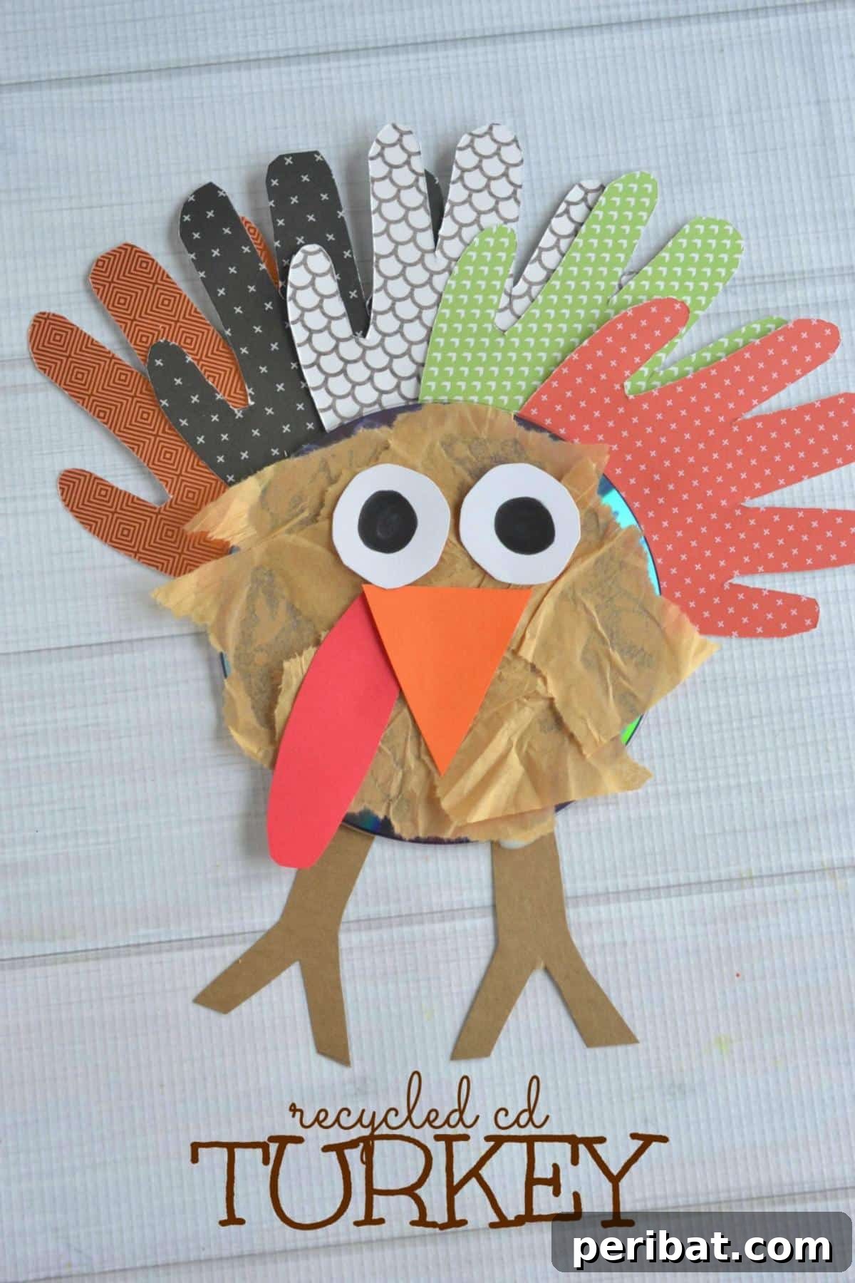 A turkey craft made from a recycled CD and handprint cutouts.