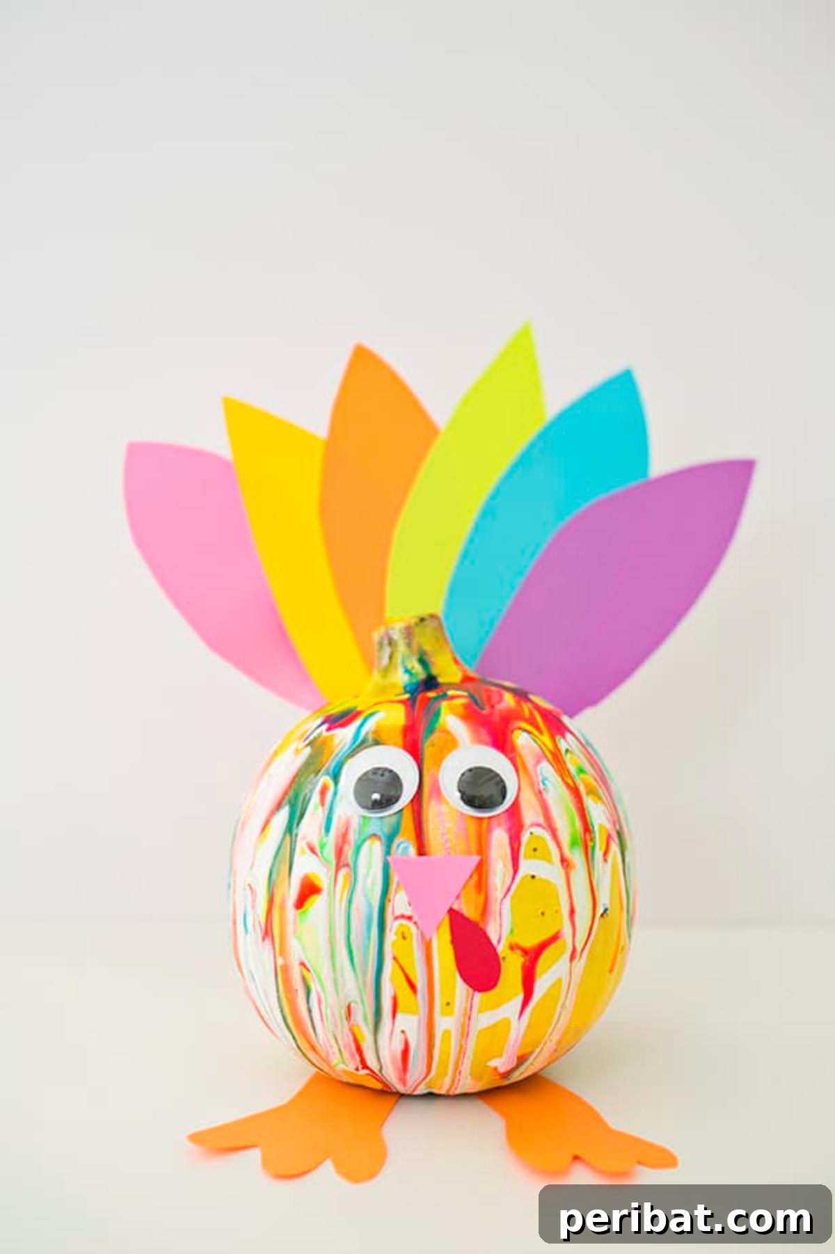 A vibrant turkey created by decorating a pumpkin with squeeze paint.